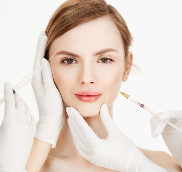 Cosmetologists hands making medical botox injections to beautiful blonde. Skin lifting. Facial treatment. Beauty and spa.
